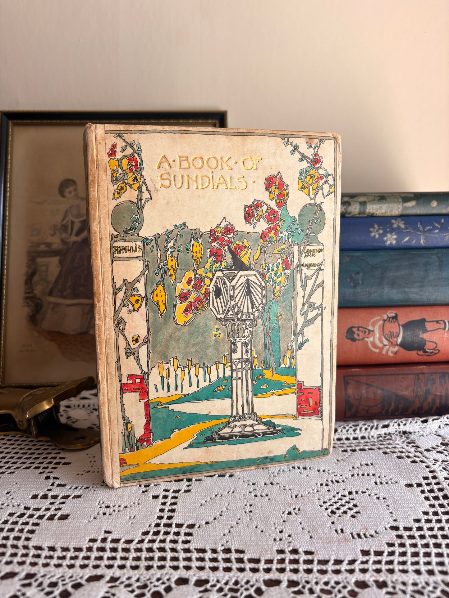 1914 The Book of Old Sundials & their Mottoes: With Eight Illustrations in Colour by Alfred Rawlings and Thirty-Six Drawings of Some Famous Sundials by Warrington Hogg. Cover designed by Jessie M. King.