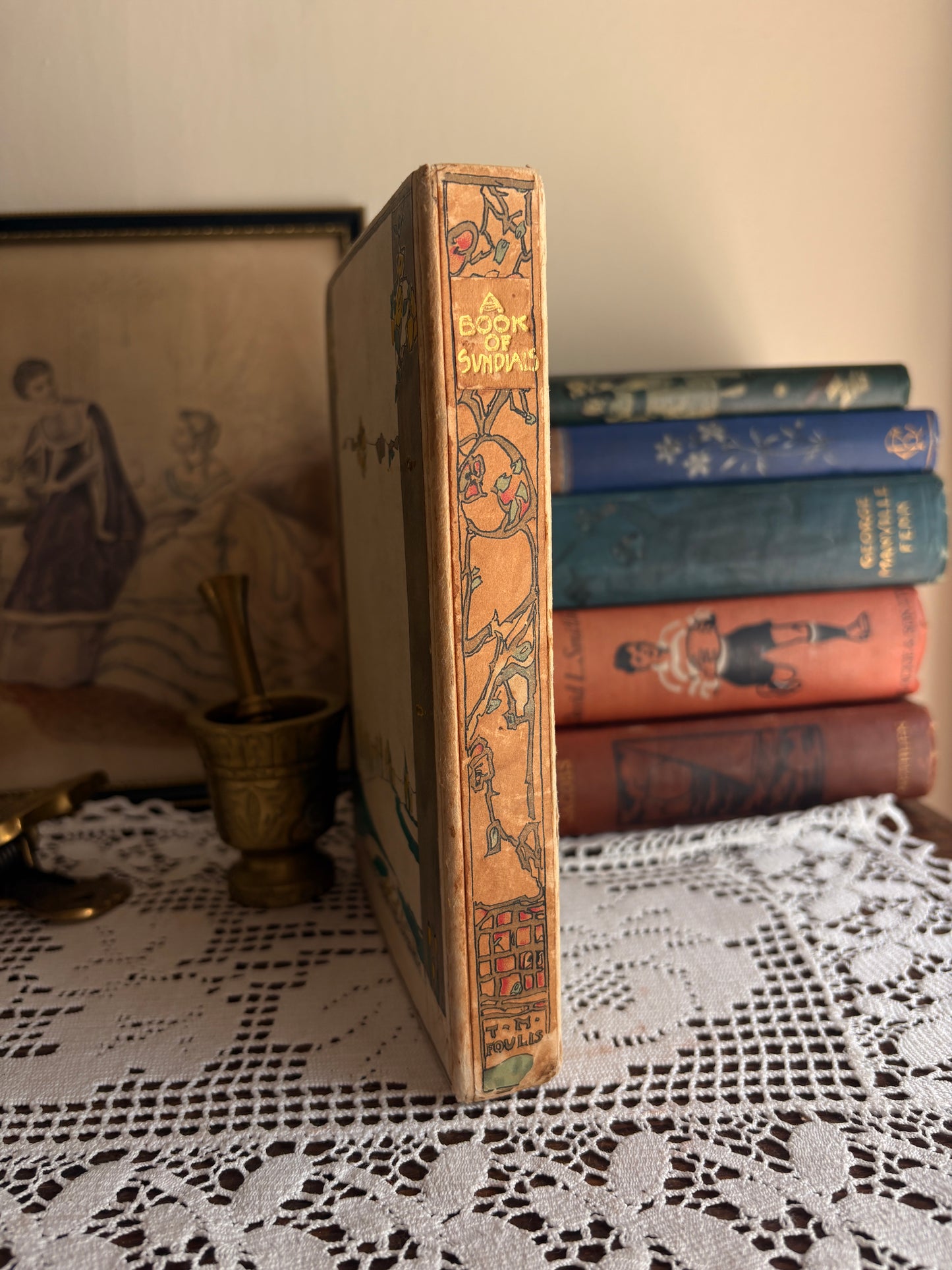 1914 The Book of Old Sundials & their Mottoes: With Eight Illustrations in Colour by Alfred Rawlings and Thirty-Six Drawings of Some Famous Sundials by Warrington Hogg. Cover designed by Jessie M. King.
